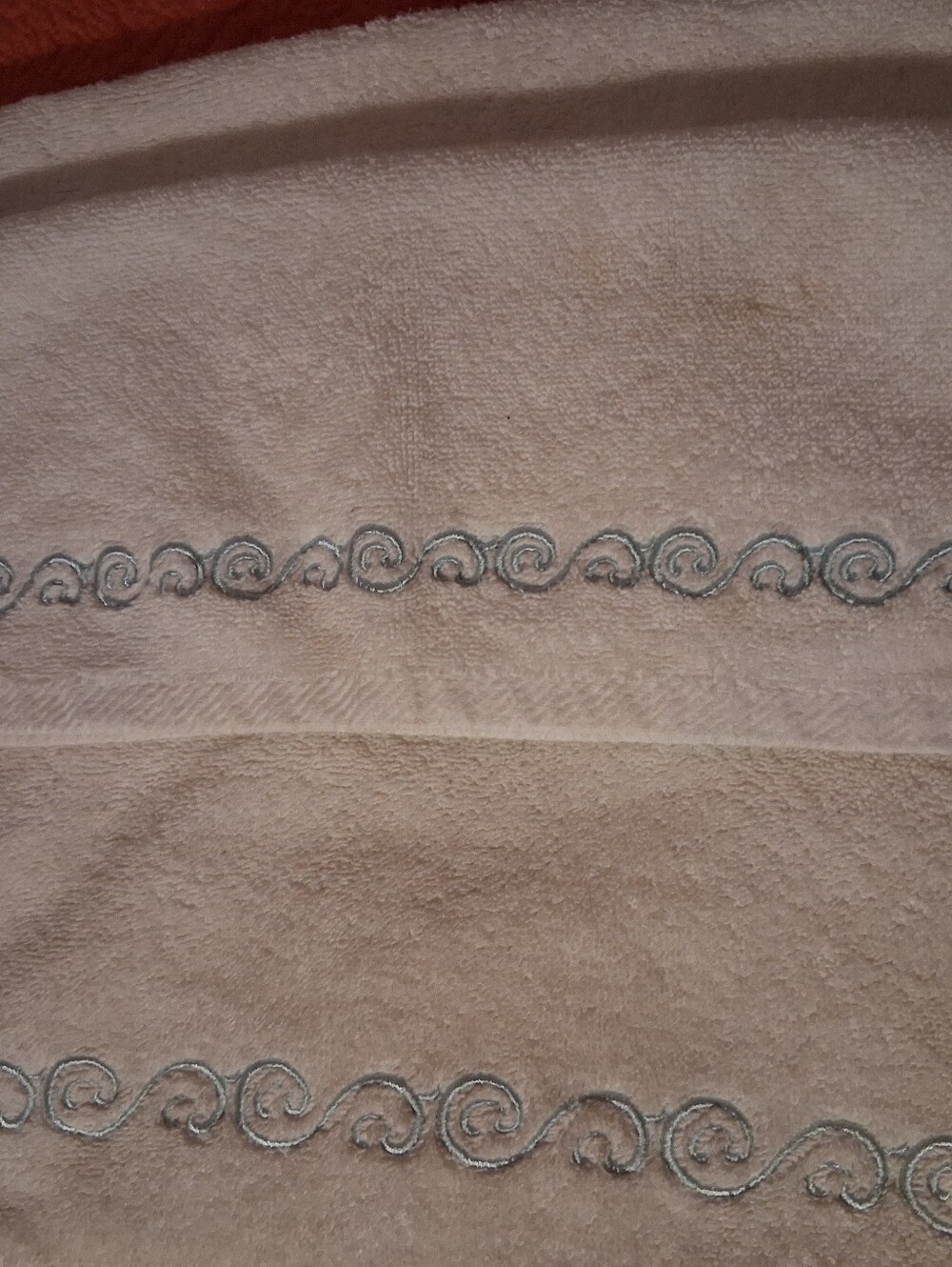 Hand Towel And Wash Cloth With Teal Design On It